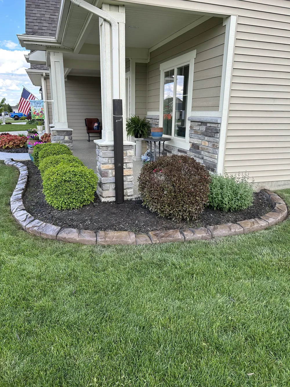 Curbscapes Outdoors concrete curbing auburn in 1 - Curbscapes Outdoors Front yard planting bed with shrubs and mulch bordered by curved concrete curbing along the porch.